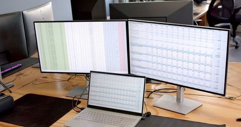 Multiple Screens Displaying Financial Data in Office Workspace - Download Free Stock Images Pikwizard.com