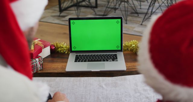 People Wearing Santa Hats Watching Laptop with Green Screen - Download Free Stock Images Pikwizard.com