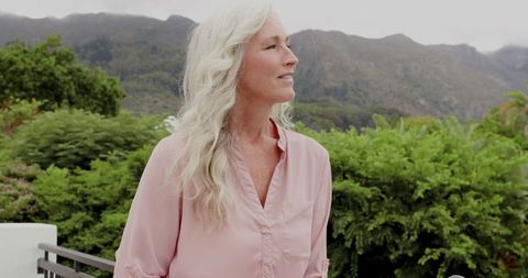 Senior Woman Contemplating Mountainous Nature Scenery