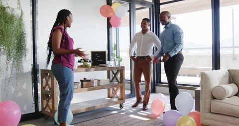 Colleagues Preparing Office with Balloons for Exciting Celebration