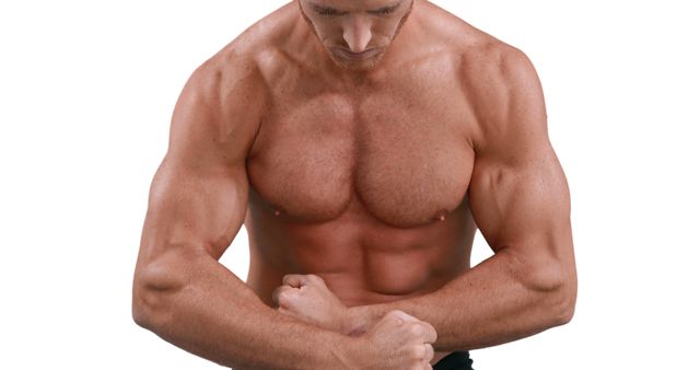 A muscular Caucasian man is showcasing his well-defined chest and arm muscles, with copy space. His pose emphasizes strength and the results of intense physical training.