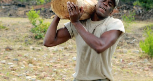 Strong Man Carrying Heavy Log Outdoors in Rural Area - Download Free Stock Images Pikwizard.com