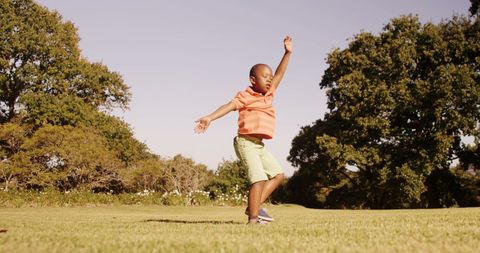 Energetic Child Practicing Acrobatics in Sunny Park