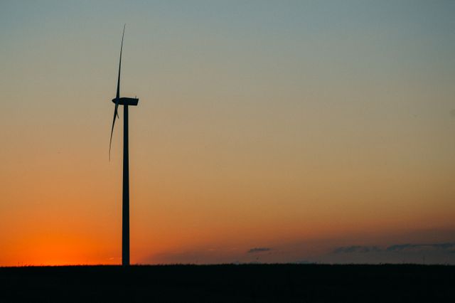 Wind turbine silhouette at sunset producing renewable energy - Download Free Stock Photos Pikwizard.com