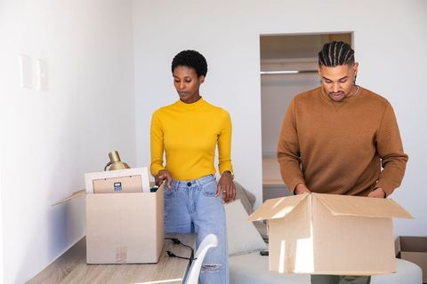 Couple Unpacking Boxes during Home Renovation