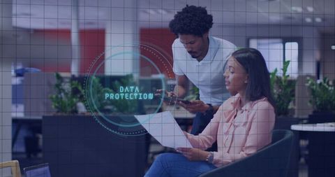 Office team reviewing data protection and privacy compliance with holographic security overlay