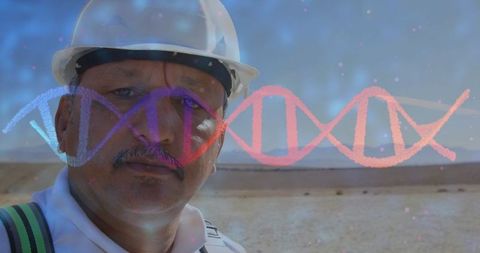 Engineer analyzing desert terrain with dna sequence overlay