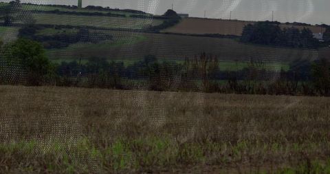 Sprawling Rural Farmland with Wind Turbine Tower