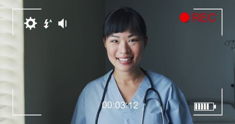Smiling Nurse in Scrubs with Stethoscope Engaging with Camera