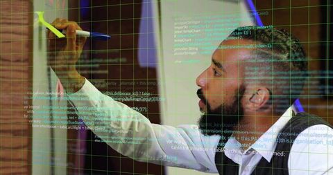 Man Coding on Glass Board in Bright Innovative Office Setting