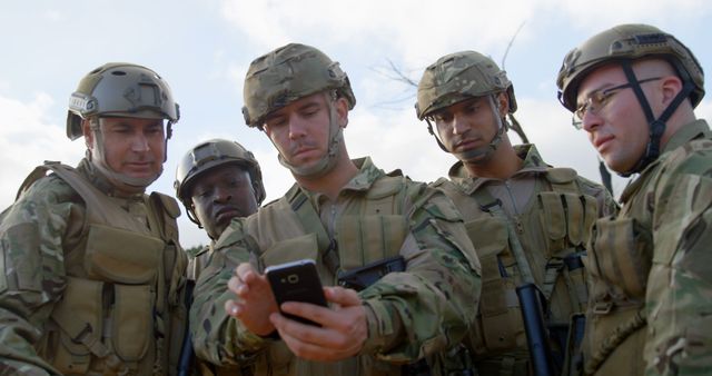 Front view of military soldiers using mobile phone during training. Military soldiers discussing over mobile phone 4k