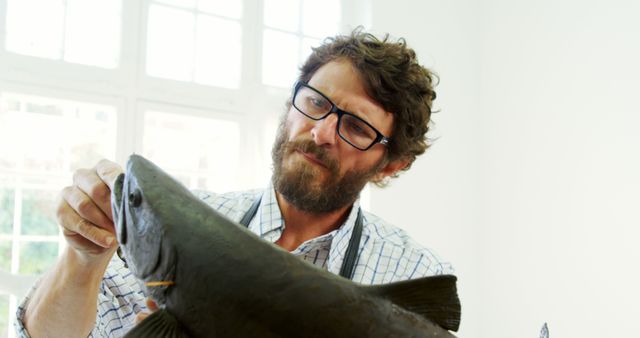 Man Examining Fish in Laboratory Setting - Download Free Stock Images Pikwizard.com
