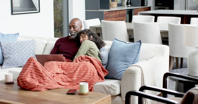 Father and Daughter Relaxing on Sofa with Laptop in Modern Living Room - Download Free Stock Images Pikwizard.com