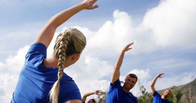 Group of friends stretching outdoors under blue sky - Download Free Stock Images Pikwizard.com