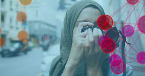 Woman in Hijab Photographing with Digital Network Overlay