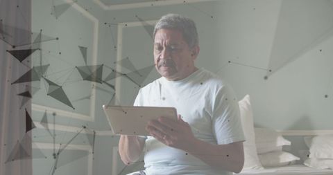 Senior Man Engaging with Digital Network on Tablet