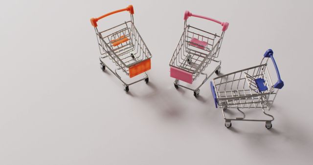 Three Miniature Shopping Carts on Grey Background - Download Free Stock Images Pikwizard.com