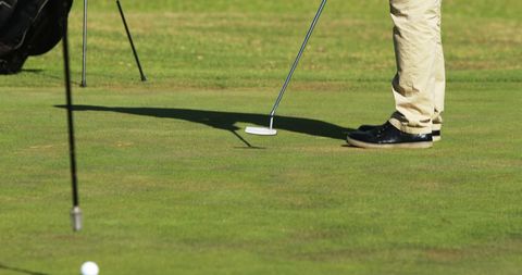 Golf Players Preparing Putt on Sunny Green Course - Download Free Stock Images Pikwizard.com