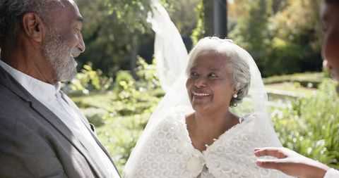 Joyful senior bride and groom embracing wedding ceremony
