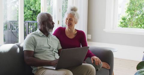 Smiling Senior Couple Enjoying Time on Laptop at Home - Download Free Stock Images Pikwizard.com