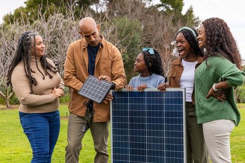 Multigenerational family exploring solar panels for home energy and sustainable living