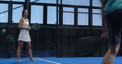 Padel Players Competing Intently on Blue Court