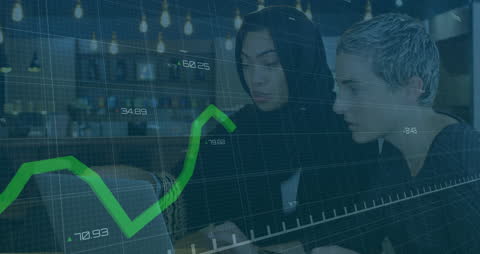 Women Analyzing Financial Data with Interactive Graphs in Modern Office