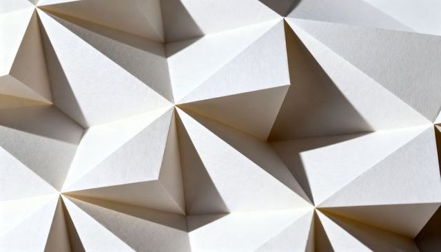 White Paper Origami Tessellated Facets with Sharp Triangular Folds and Dramatic Shadows