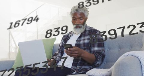 Man Managing Digital Data Surrounded by Information Flow at Home