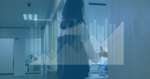 Data analytics concept: woman walking through modern office