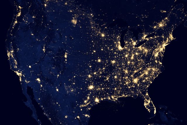Glowing city lights of the United States highlight urban areas visible from space at night, showing dense population centers and geographical spread. Useful for materials on urbanization, geography, and astronomical studies. Valuable for technology, infrastructure planning, educational purposes, and visualizing human settlements.