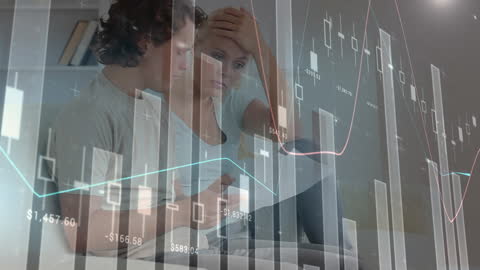 Couple Analyzing Financial Charts at Home