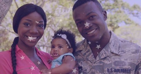 Happy military family outdoors with laughing baby