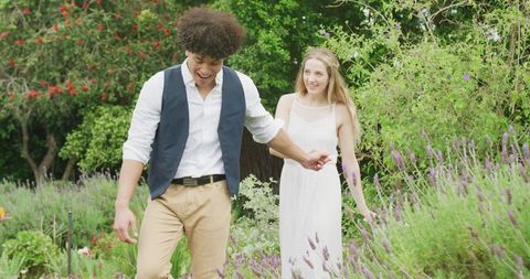 Joyful Interracial Couple Strolling Through Lush Garden