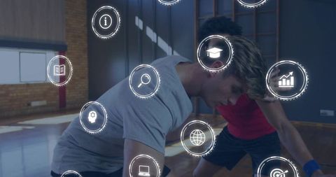 Two male athletes training on gym floor with futuristic holographic performance icons