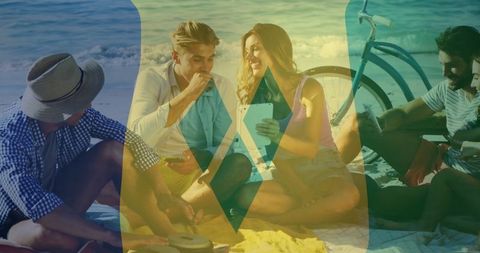 Friends Enjoying Beach Picnic With Tablet and Bicycle