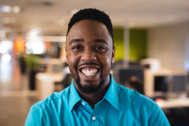 Portrait of cheerful young african american businessman working in office. unaltered, business, corporate business, occupation and office concept.