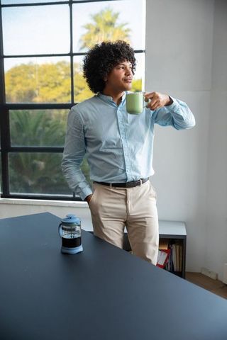 Confident Professional Enjoying Coffee Break at Modern Office