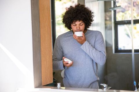 Man Practicing Skincare Routine in Modern Bathroom