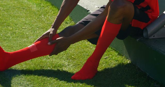 Soccer Player Sitting and Holding Injured Leg on Green Field - Download Free Stock Images Pikwizard.com