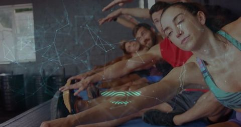 Group fitness class stretching forward on mats with futuristic data overlay