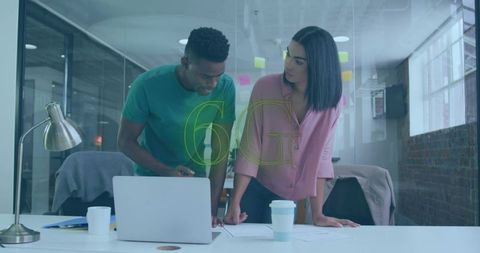 Colleagues Collaborating on 6G Innovation in Modern Office Space