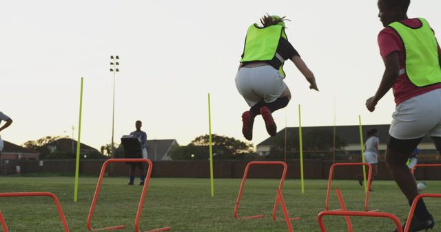 Teenage Girls Training on Soccer Field with Hurdles and Poles - Download Free Stock Images Pikwizard.com