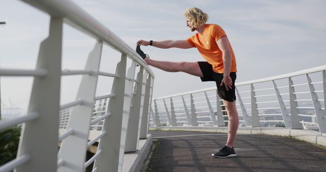 Young Man Stretching on Bridge During Morning Workout - Download Free Stock Images Pikwizard.com