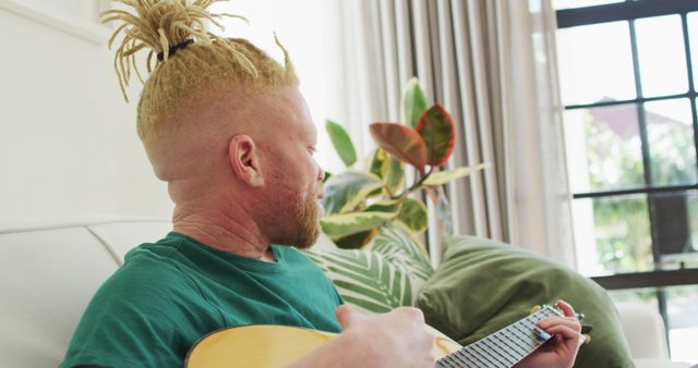 Man with Dreadlocks Playing Guitar at Home - Download Free Stock Images Pikwizard.com