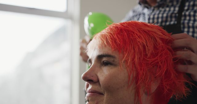 Hairdresser styling woman's bright red hair in salon - Download Free Stock Images Pikwizard.com