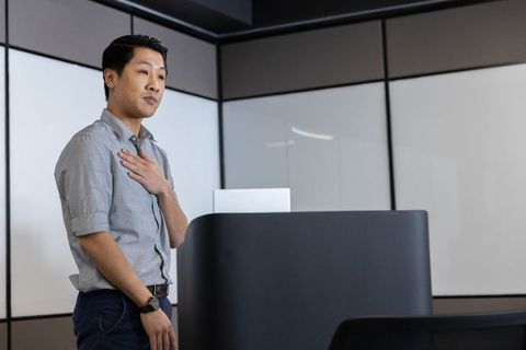 Confident Businessman Presenting in Modern Conference Room
