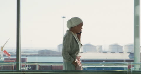 Confident Businesswoman in Hijab Engaging in Call at Office