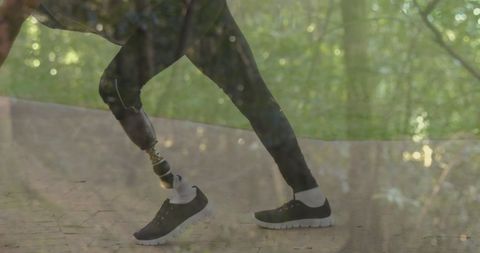 Man with prosthetic leg stretching outdoors