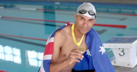 Swimmer Celebrates Gold Medal Achievement at Swimming Pool - Download Free Stock Images Pikwizard.com